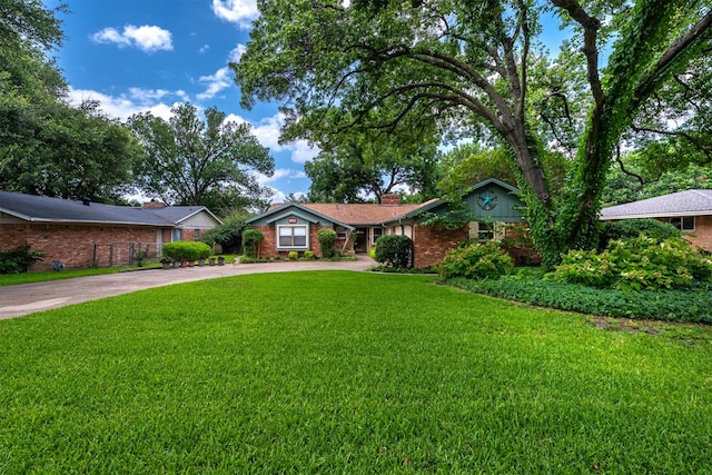 5912 Whitman Ave, Fort Worth, TX 76133 - single story home featuring driveway, a front yard, brick siding, and a chimney