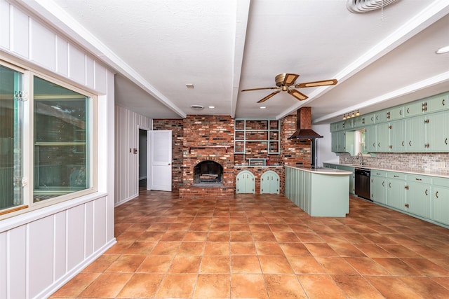 5912 Whitman Ave, Fort Worth, TX 76133 - kitchen with green cabinetry, dishwasher, wall chimney exhaust hood, a ceiling fan, and a fireplace