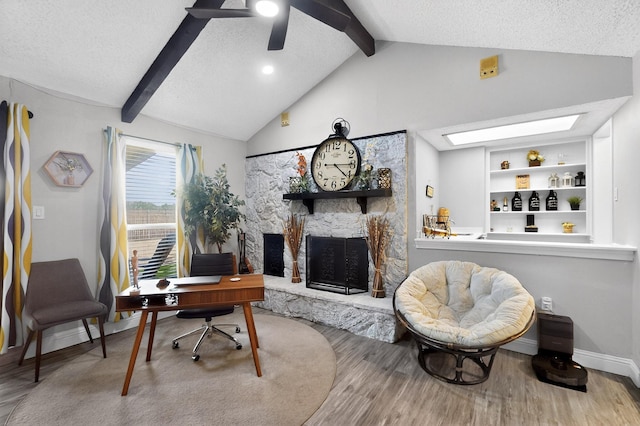 5700 Kingstree Ct, Arlington, TX 76017 - office area with wood finished floors, a fireplace, ceiling fan, a textured ceiling, and a skylight