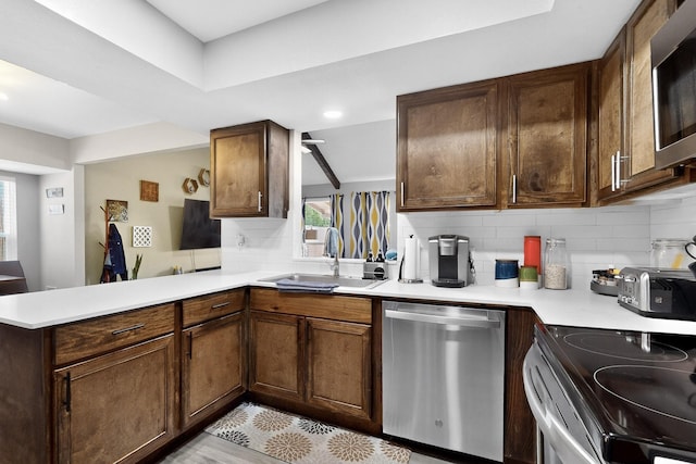 5700 Kingstree Ct, Arlington, TX 76017 - kitchen with stainless steel appliances, tasteful backsplash, light countertops, a peninsula, and recessed lighting