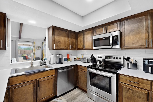 5700 Kingstree Ct, Arlington, TX 76017 - kitchen with stainless steel appliances, tasteful backsplash, light countertops, and light wood-style floors