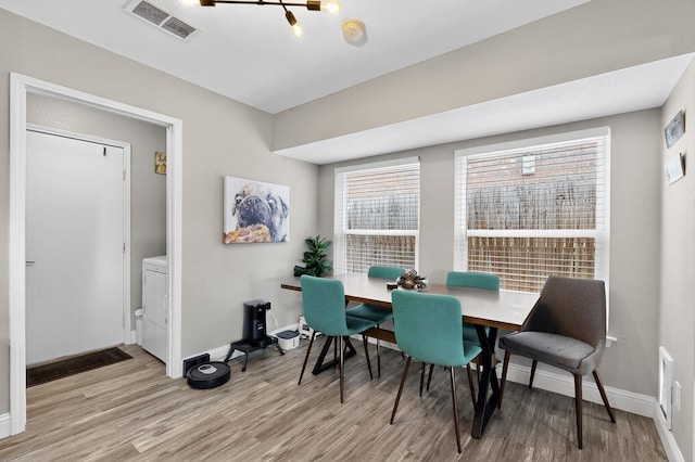 5700 Kingstree Ct, Arlington, TX 76017 - dining room with wood finished floors, washer / clothes dryer, and a chandelier