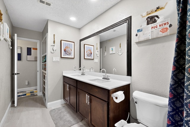 5700 Kingstree Ct, Arlington, TX 76017 - bathroom featuring double vanity and a textured ceiling