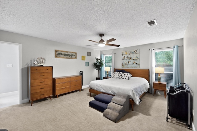 5700 Kingstree Ct, Arlington, TX 76017 - bedroom with multiple windows, light carpet, a ceiling fan, and a textured ceiling