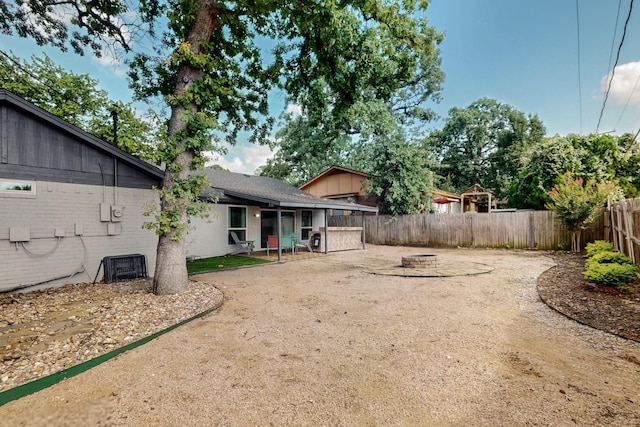5700 Kingstree Ct, Arlington, TX 76017 - fenced backyard featuring a fire pit and a patio area