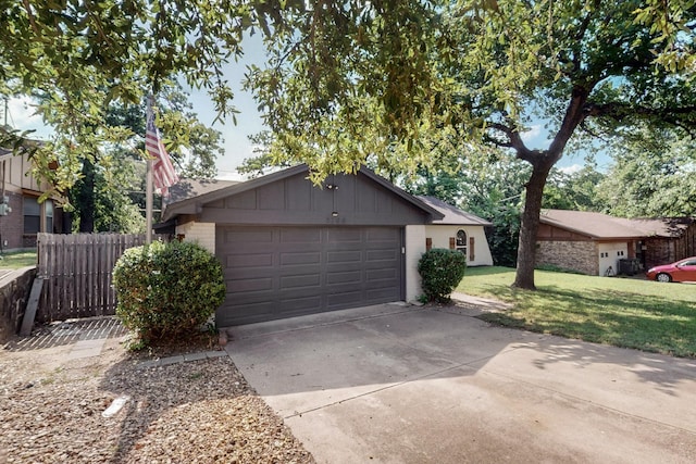 5700 Kingstree Ct, Arlington, TX 76017 - view of front of home featuring an attached garage, driveway, brick siding, and board and batten siding