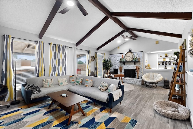 5700 Kingstree Ct, Arlington, TX 76017 - living room featuring a ceiling fan, wood finished floors, a textured ceiling, and a fireplace