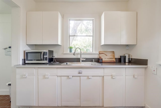 4711 Birchman Ave, Fort Worth, TX 76107 - kitchen featuring stainless steel microwave, white cabinets, and light countertops