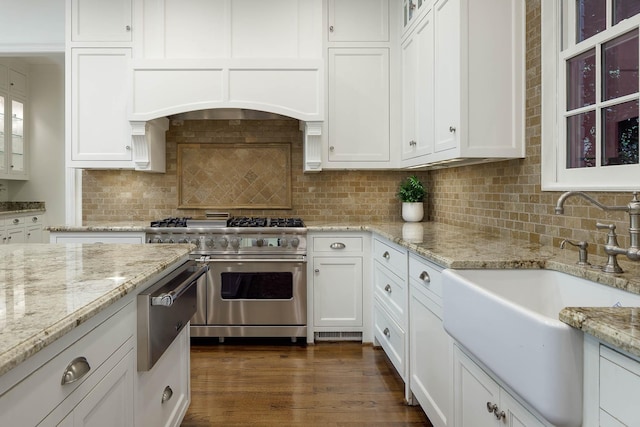3817 Centenary Ave, University Park, TX 75225 - kitchen with stainless steel stove, white cabinetry, glass insert cabinets, and tasteful backsplash