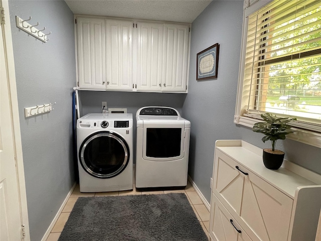 101 Branch St, Pittsburg, TX 75686 - washroom featuring separate washer and dryer, cabinet space, and light tile patterned flooring