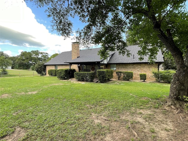 101 Branch St, Pittsburg, TX 75686 - rear view of property with a shingled roof, a chimney, and brick siding