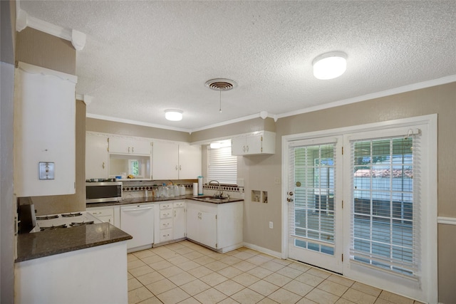 104 Charles Ln, Terrell, TX 75160 - kitchen with dishwasher, stainless steel microwave, ornamental molding, a textured ceiling, and white cabinets