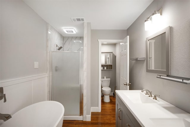 104 Charles Ln, Terrell, TX 75160 - bathroom with wood finished floors, a stall shower, double vanity, and a freestanding bath