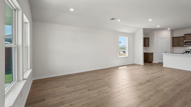 441 Drake Dr, Ferris, TX 75125 - unfurnished living room with light wood-style flooring and recessed lighting