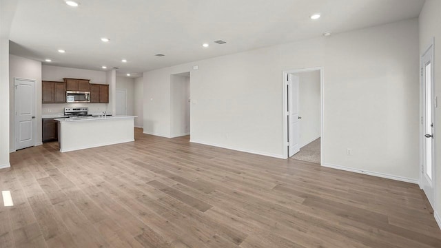 441 Drake Dr, Ferris, TX 75125 - unfurnished living room featuring light wood finished floors and recessed lighting