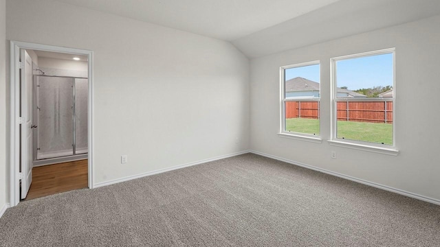 441 Drake Dr, Ferris, TX 75125 - unfurnished bedroom featuring carpet floors, lofted ceiling, and connected bathroom