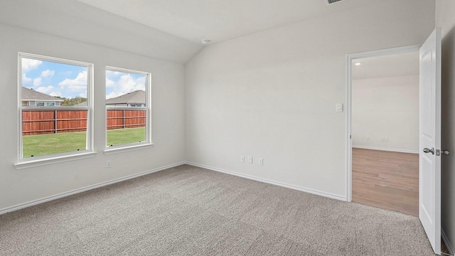 441 Drake Dr, Ferris, TX 75125 - carpeted spare room featuring lofted ceiling and baseboards