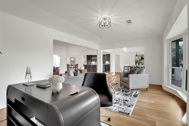 6910 Midcrest Dr, Dallas, TX 75254 - office area featuring light wood-style floors and a chandelier