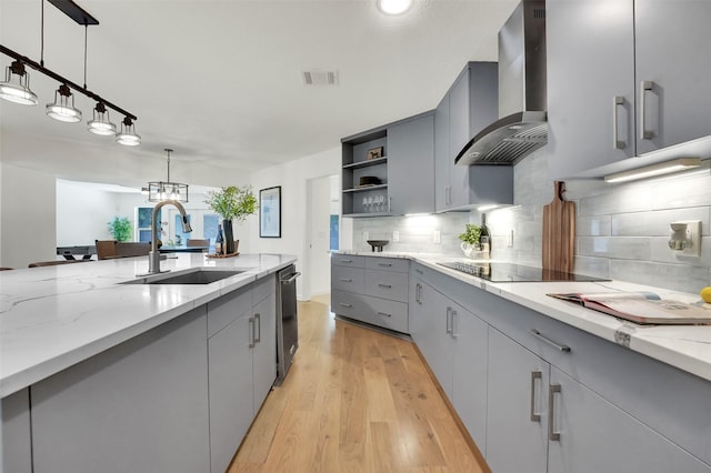6910 Midcrest Dr, Dallas, TX 75254 - kitchen featuring wall chimney range hood, gray cabinets, light wood-style floors, open shelves, and backsplash