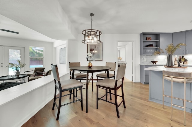 6910 Midcrest Dr, Dallas, TX 75254 - dining space featuring light wood-type flooring and a chandelier