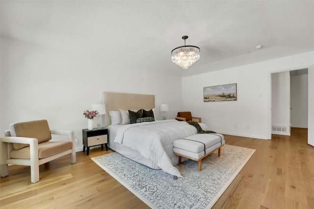 6910 Midcrest Dr, Dallas, TX 75254 - bedroom with light wood-style floors and a chandelier