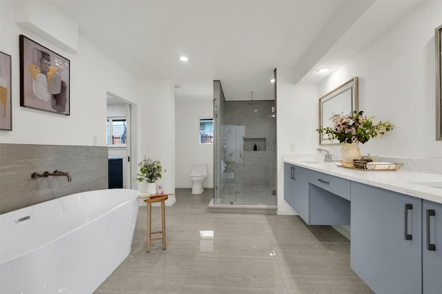 6910 Midcrest Dr, Dallas, TX 75254 - bathroom with a stall shower, double vanity, a soaking tub, and recessed lighting