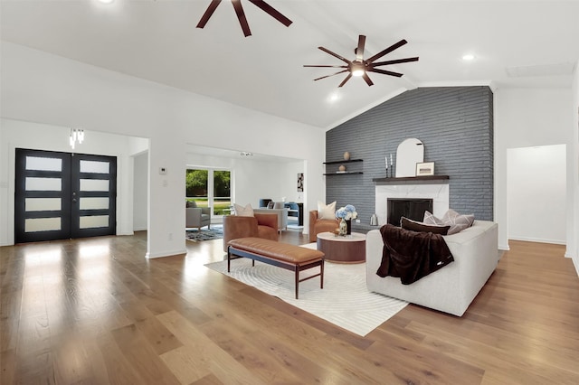6910 Midcrest Dr, Dallas, TX 75254 - living room featuring a ceiling fan, lofted ceiling, a high end fireplace, wood finished floors, and french doors