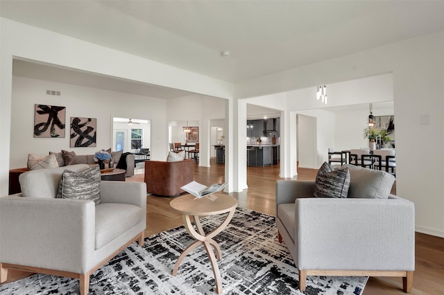 6910 Midcrest Dr, Dallas, TX 75254 - living room with wood finished floors and a chandelier