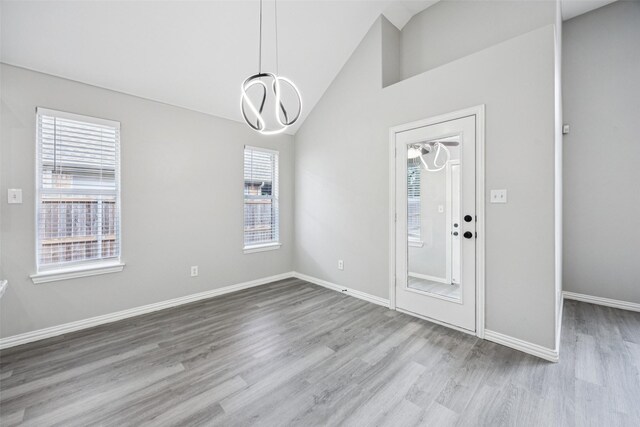 6945 Stockton Dr, Fort Worth, TX 76132 - unfurnished dining area featuring wood finished floors, a chandelier, and high vaulted ceiling