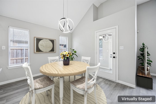 6945 Stockton Dr, Fort Worth, TX 76132 - dining space with wood finished floors, a chandelier, and high vaulted ceiling