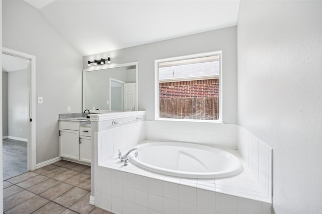 6945 Stockton Dr, Fort Worth, TX 76132 - bathroom featuring vanity, a garden tub, lofted ceiling, and tile patterned floors