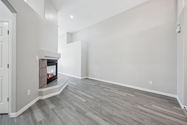 6945 Stockton Dr, Fort Worth, TX 76132 - unfurnished living room featuring wood finished floors, arched walkways, a fireplace, and recessed lighting
