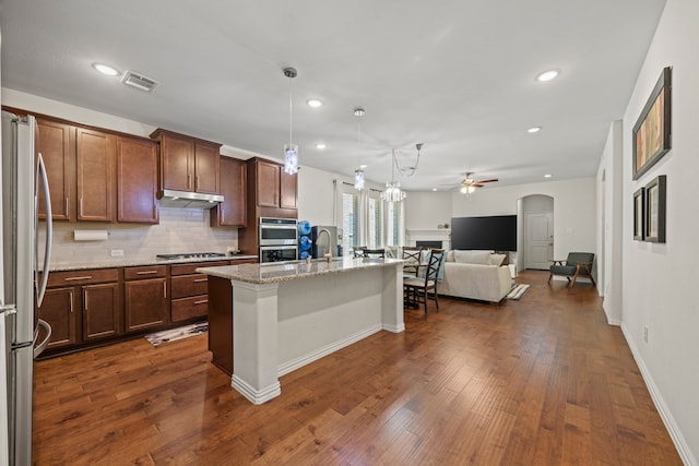 2025 Meliana Dr, Little Elm, TX 75068 - kitchen with stainless steel appliances, ceiling fan, under cabinet range hood, recessed lighting, and open floor plan