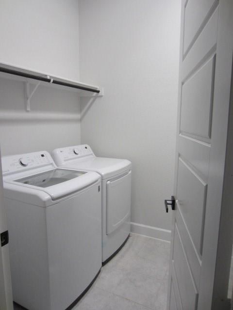 1813 Terrace Way, Argyle, TX 76226 - laundry area with washing machine and clothes dryer and baseboards