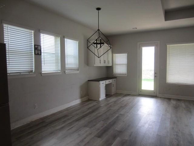 1813 Terrace Way, Argyle, TX 76226 - unfurnished dining area with baseboards and wood finished floors