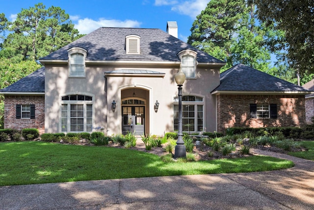 9664 Norris Ferry Rd, Shreveport, LA 71106 - french country inspired facade with a chimney, french doors, brick siding, and a front yard