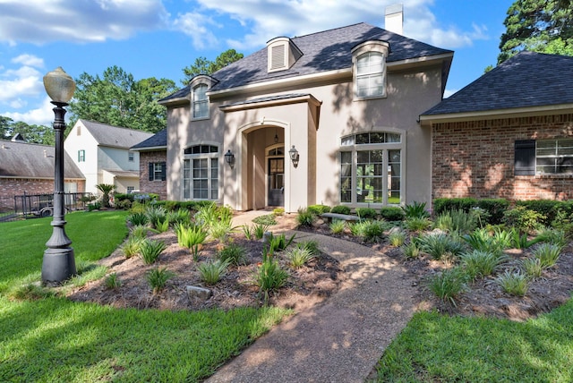 9664 Norris Ferry Rd, Shreveport, LA 71106 - french country inspired facade featuring stucco siding, a chimney, brick siding, and a shingled roof
