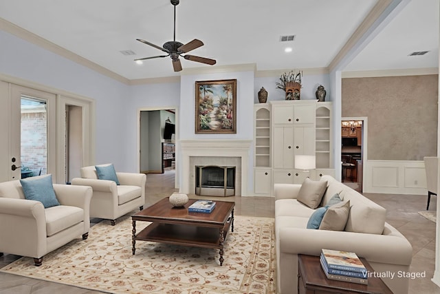9664 Norris Ferry Rd, Shreveport, LA 71106 - living room with ceiling fan, ornamental molding, a fireplace, a decorative wall, and wainscoting