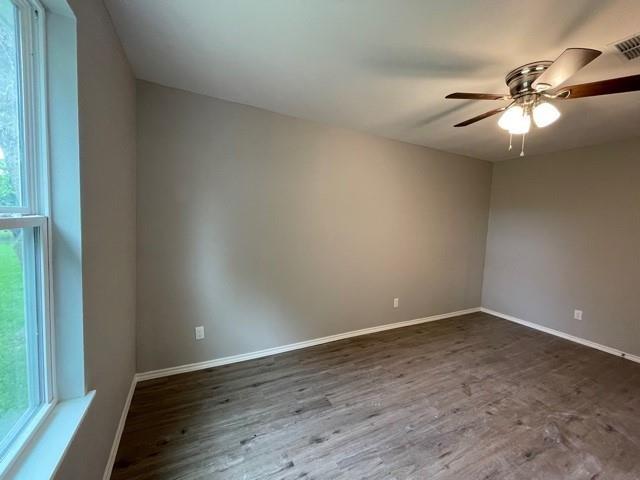4601 Cox St, Sherman, TX 75090 - spare room featuring dark wood finished floors and ceiling fan