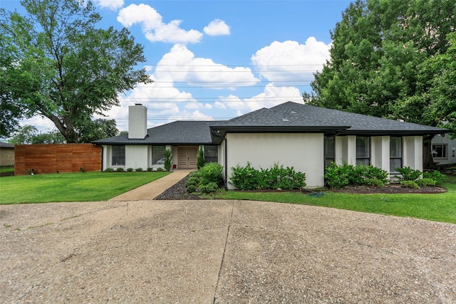 12211 Quincy Ln, Dallas, TX 75230 - view of front facade featuring a chimney, a shingled roof, stucco siding, and concrete driveway