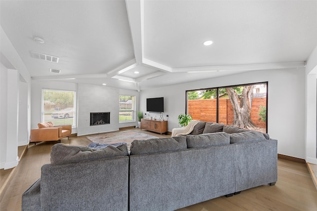 12211 Quincy Ln, Dallas, TX 75230 - living room featuring light wood-type flooring, plenty of natural light, a large fireplace, recessed lighting, and lofted ceiling
