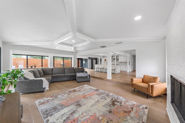 12211 Quincy Ln, Dallas, TX 75230 - living room with a fireplace, light wood-type flooring, and recessed lighting