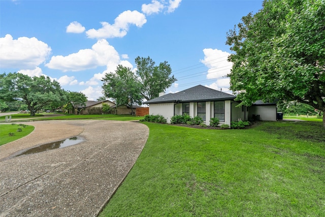 12211 Quincy Ln, Dallas, TX 75230 - view of property exterior with a lawn and curved driveway