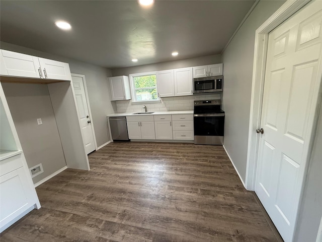 5506 Urbanview St, Sansom Park, TX 76114 - kitchen with appliances with stainless steel finishes, tasteful backsplash, white cabinets, dark wood-style floors, and recessed lighting