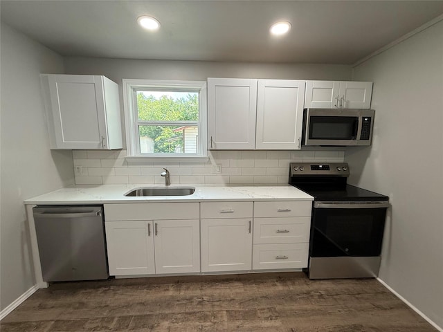 5506 Urbanview St, Sansom Park, TX 76114 - kitchen with appliances with stainless steel finishes, tasteful backsplash, white cabinetry, and recessed lighting