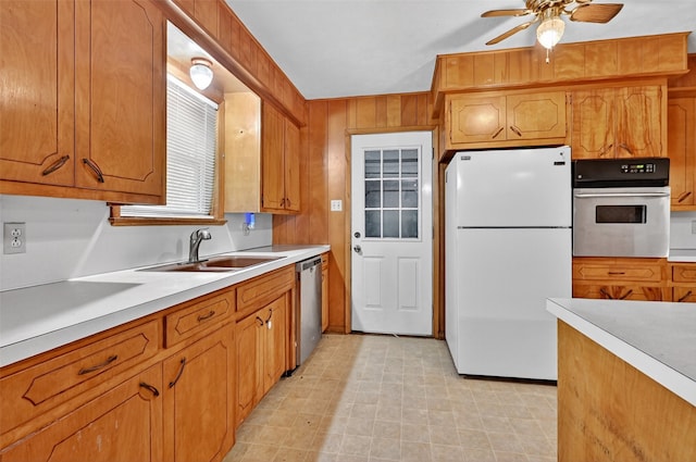 12906 Fm 902, Dorchester, TX 75459 - kitchen featuring appliances with stainless steel finishes, ceiling fan, light countertops, and brown cabinets
