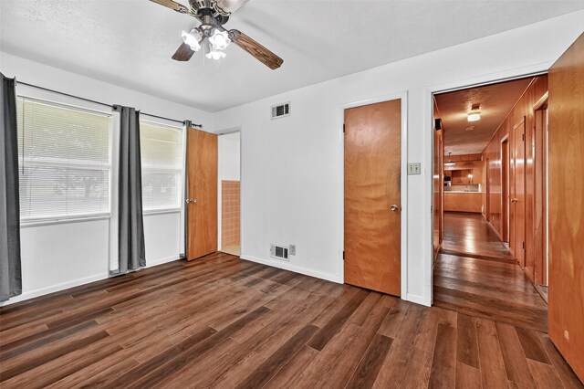 12906 Fm 902, Dorchester, TX 75459 - unfurnished bedroom with dark wood-type flooring and ceiling fan