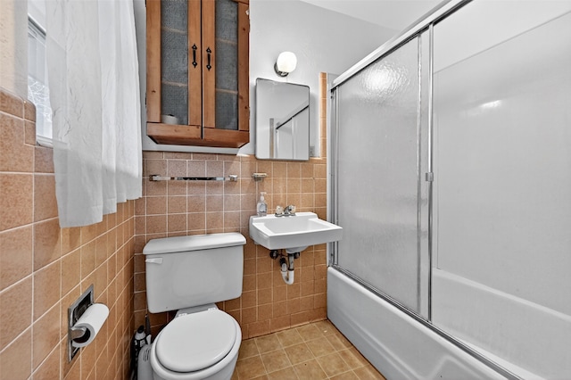 12906 Fm 902, Dorchester, TX 75459 - full bath featuring tile walls, enclosed tub / shower combo, tile patterned flooring, and wainscoting