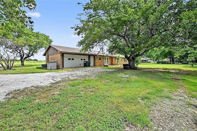 12906 Fm 902, Dorchester, TX 75459 - view of front of home featuring brick siding, a front lawn, driveway, and a garage