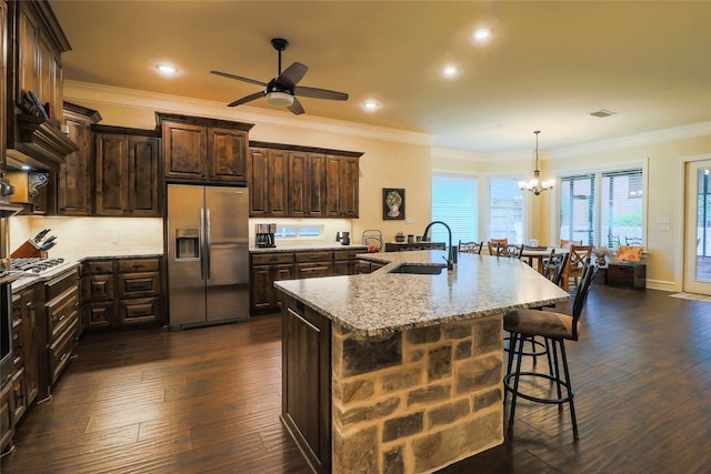 6923 Saint Anthony Dr, Tyler, TX 75703 - kitchen featuring stainless steel fridge, a breakfast bar area, ceiling fan, dark wood finished floors, and crown molding